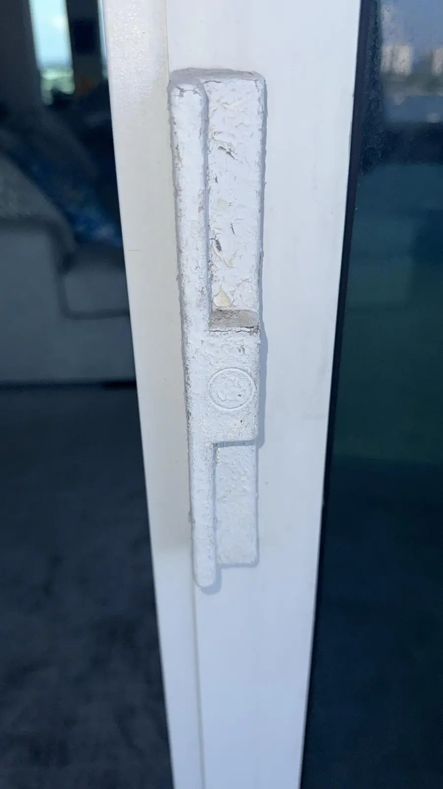 Damaged sliding door handle showing wear and mechanism issues