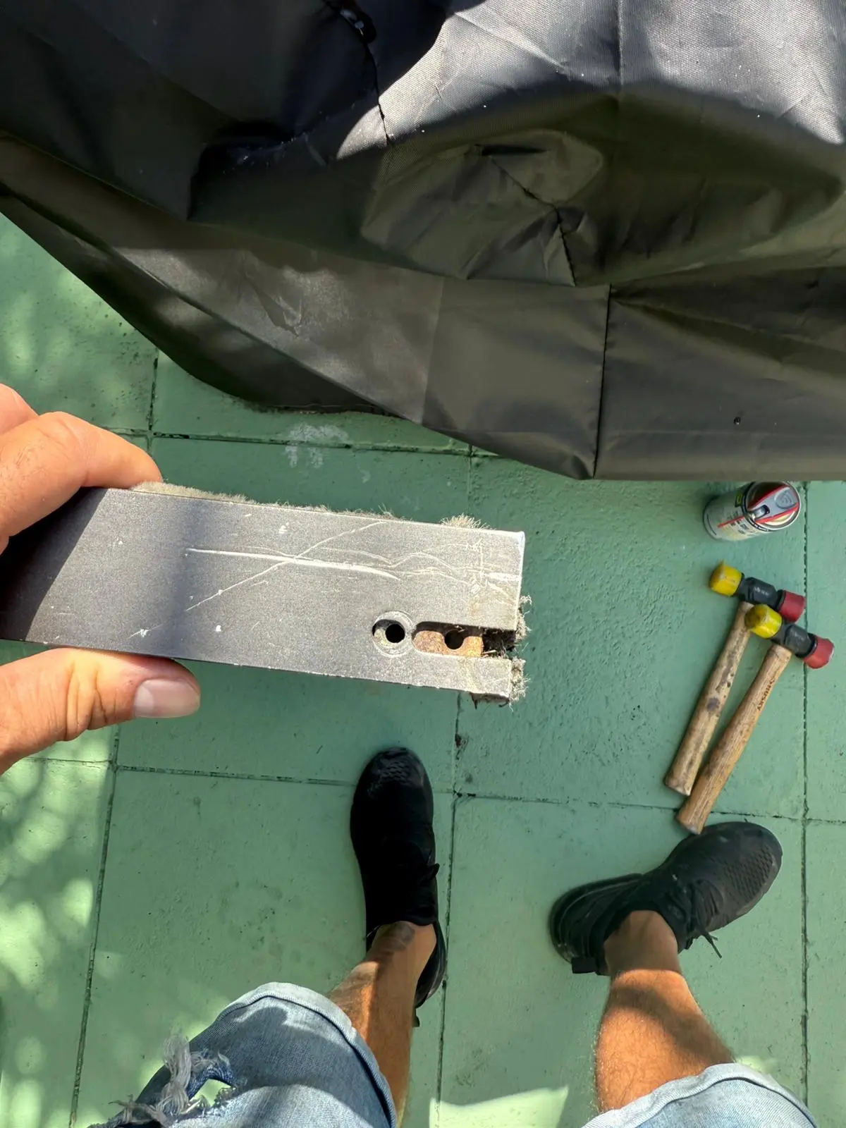Sliding door roller mechanism component showing wear and damage