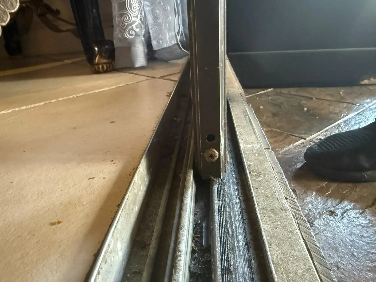 Sliding door track repair showing damaged track components